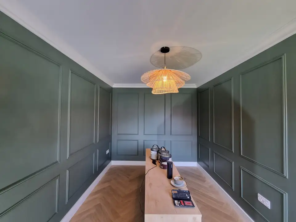 Dining room with sage green painted wall panelling and white ceiling, decorated by Hields Decorating Services near York