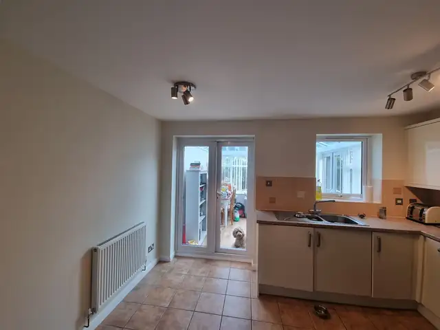 Cream kitchen walls with a white radiator and French doors